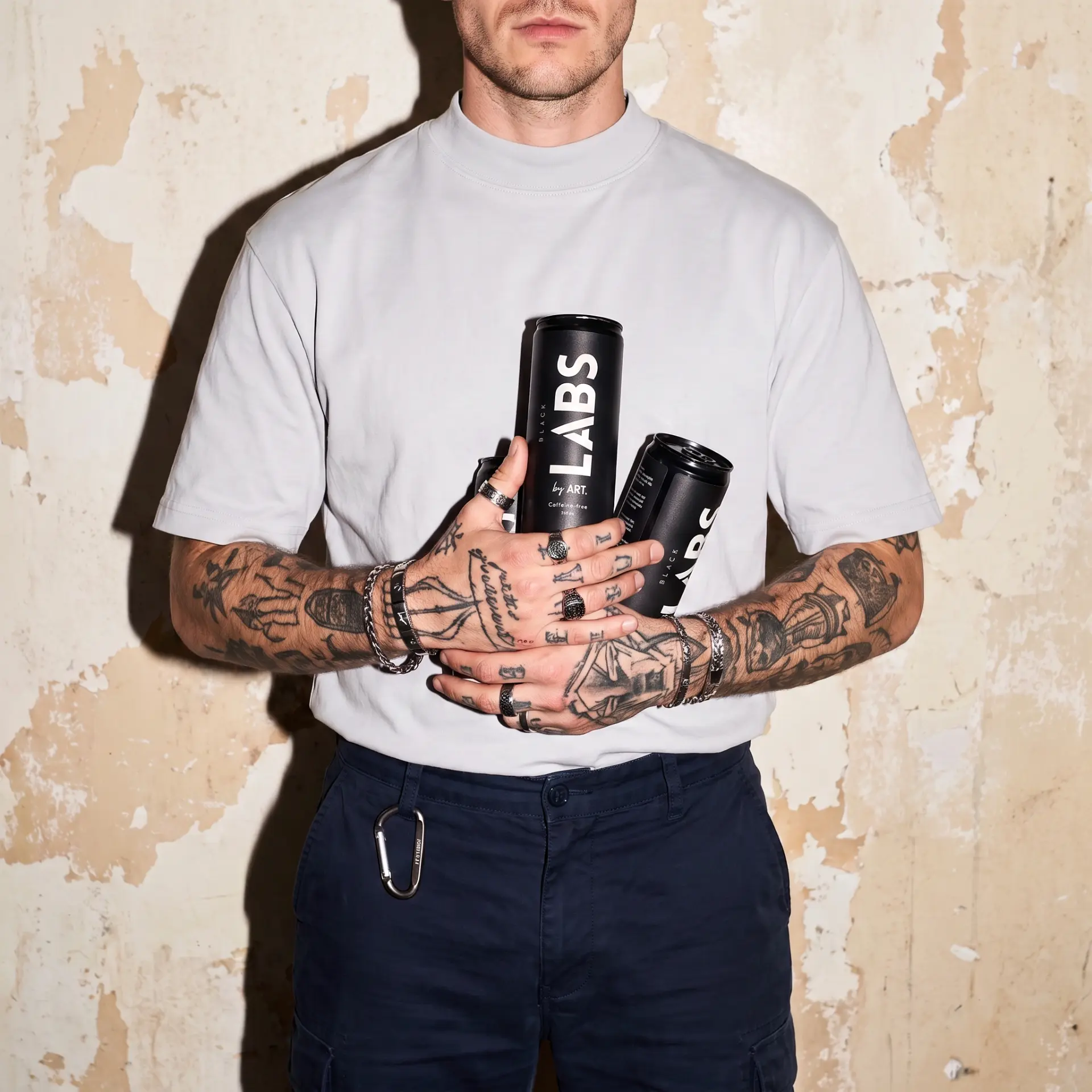 Athlete holding matte black LABS cans